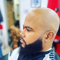 Clean head shave with a shaped beard